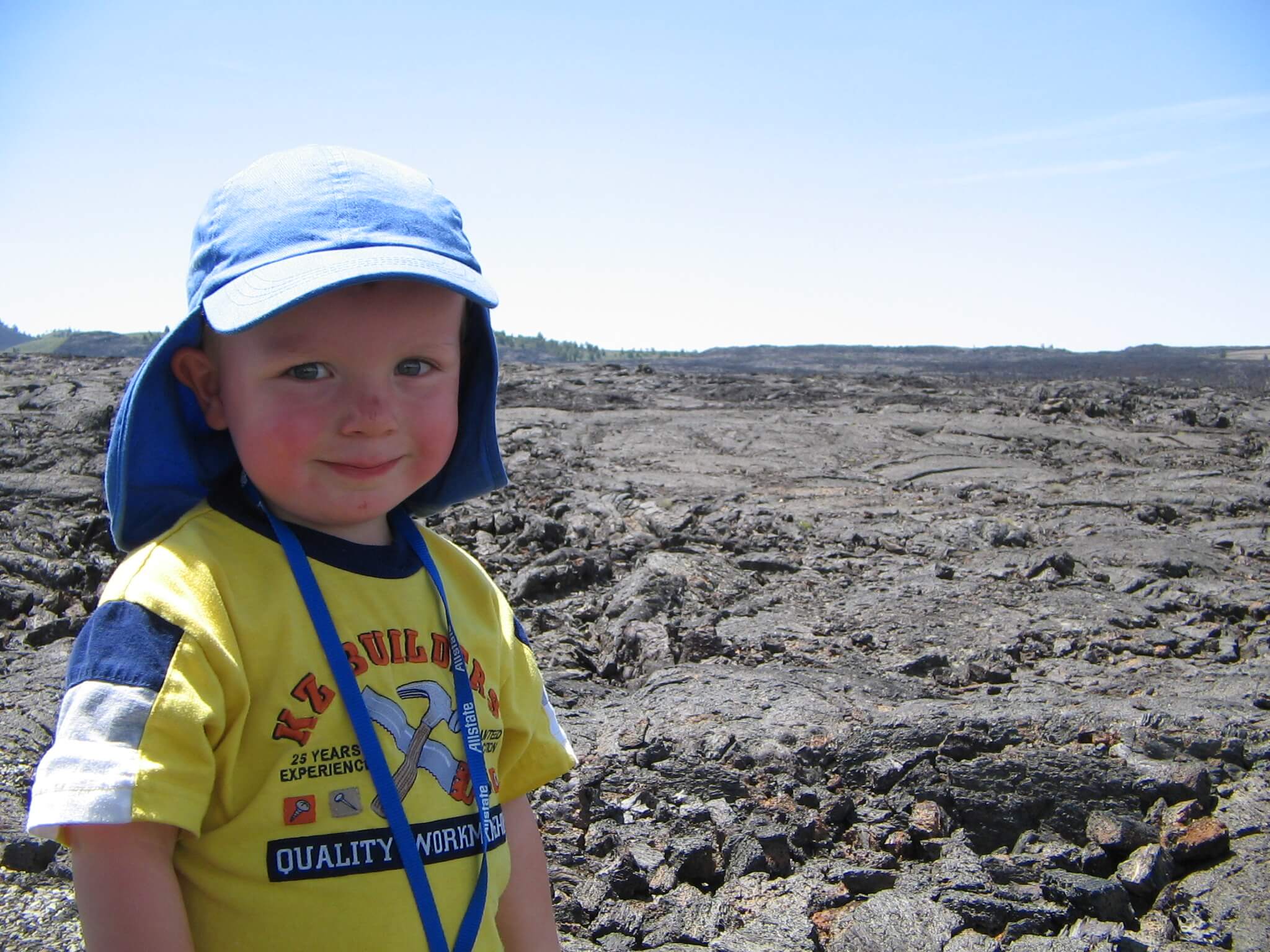 Full original Craters of the Moon photograph showing the child and textured lava field